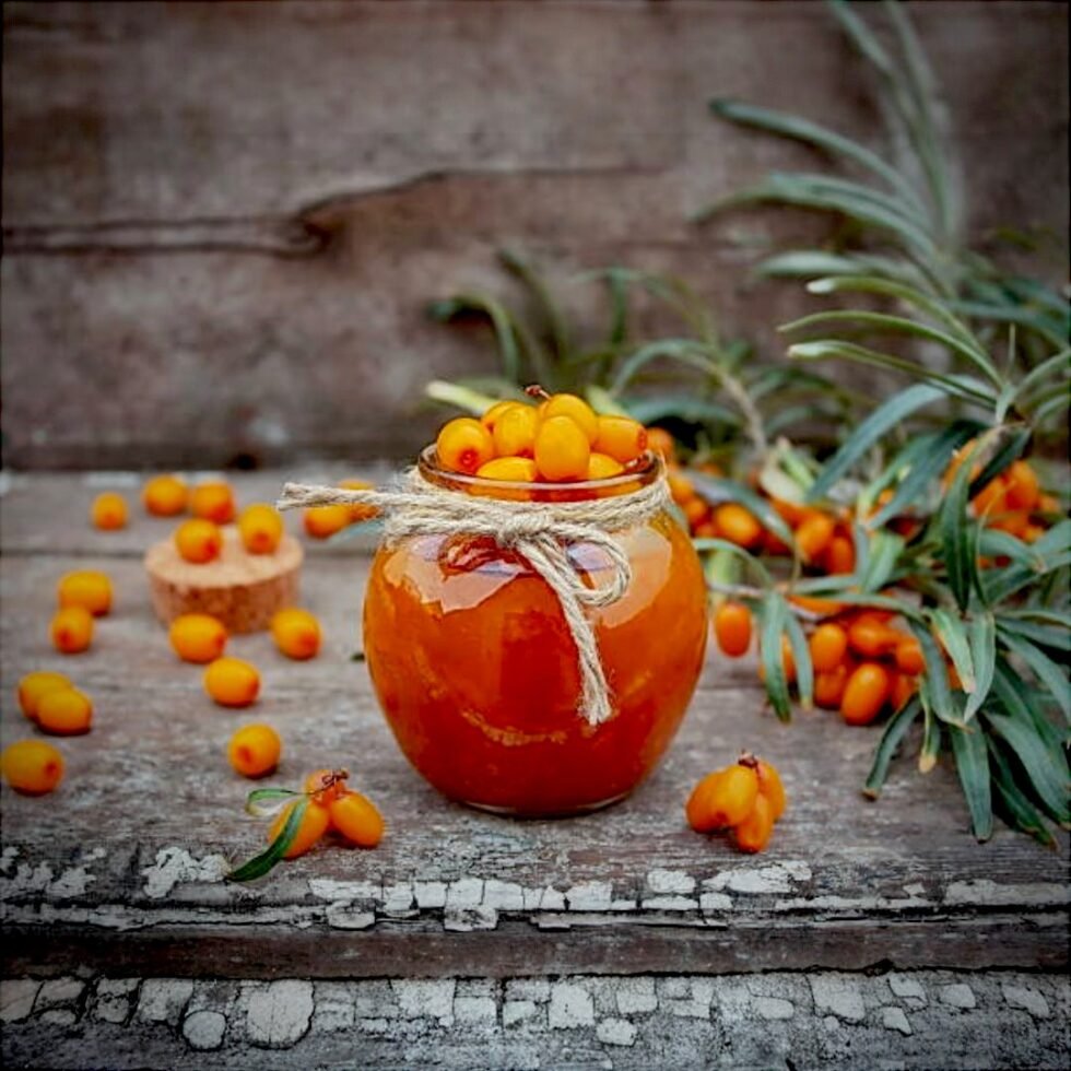 Homemade sea buckthorn jam in a glass jar, made from handpicked berries from the Himalayas, showcasing its rich golden-orange color and thick texture – a tangy, nutritious delight from Himachal Pradesh.