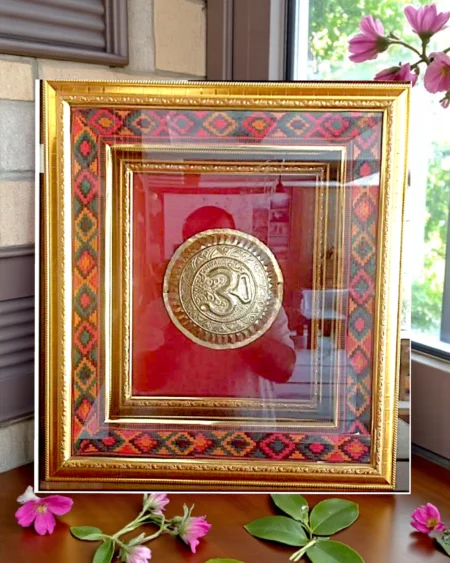 Brass Om Framed Wall Art with Kullu Border and Red Background